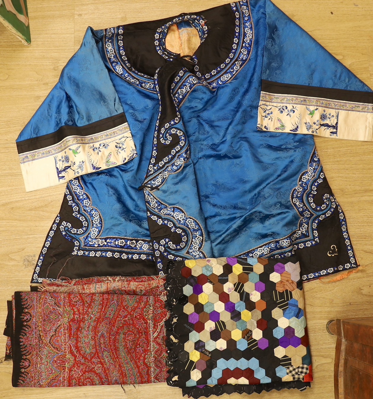 A Chinese silk robe, a 19th century patchwork panel and a panel from a Paisley summer shawl and a black parasol